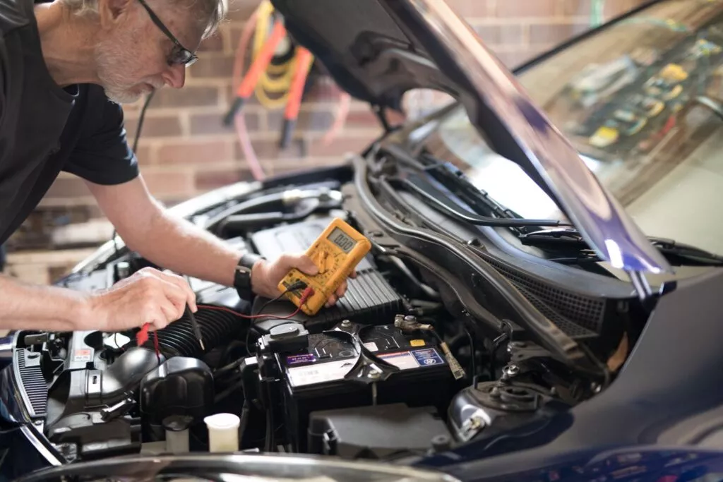 Certified mechanic performing advanced engine diagnostics